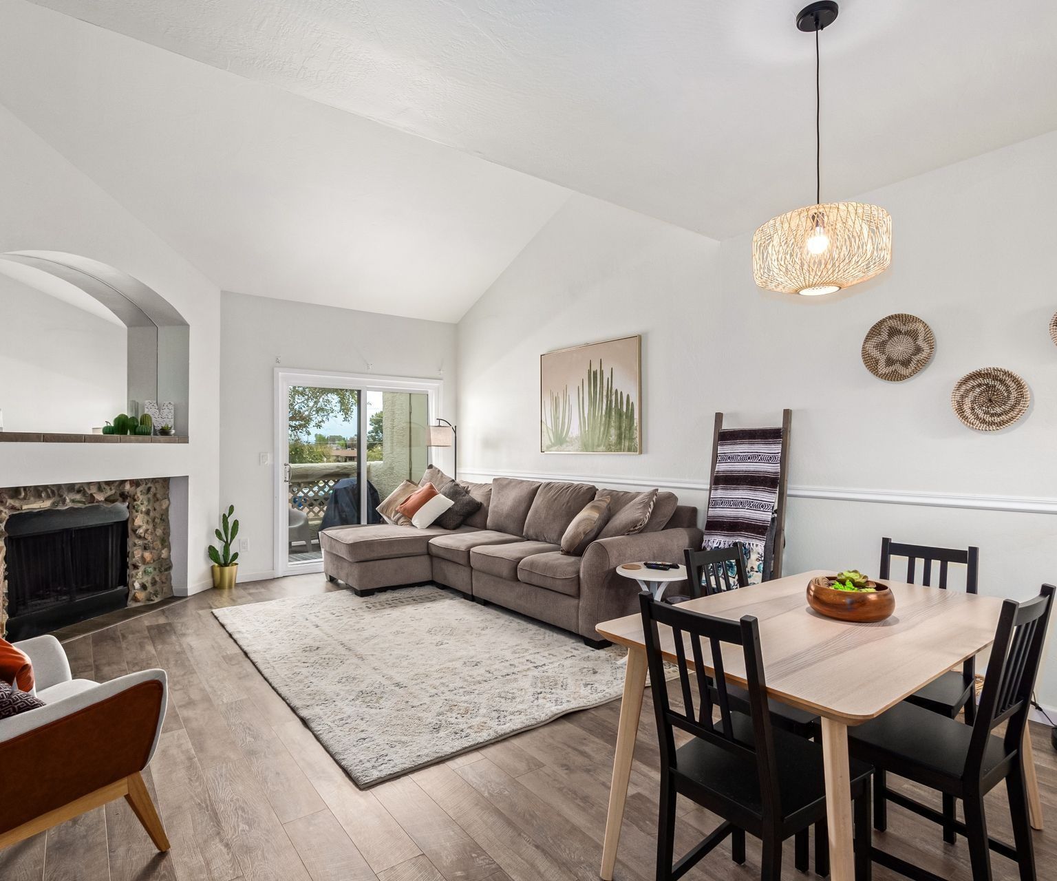 Bright living room with a fireplace and vaulted ceiling