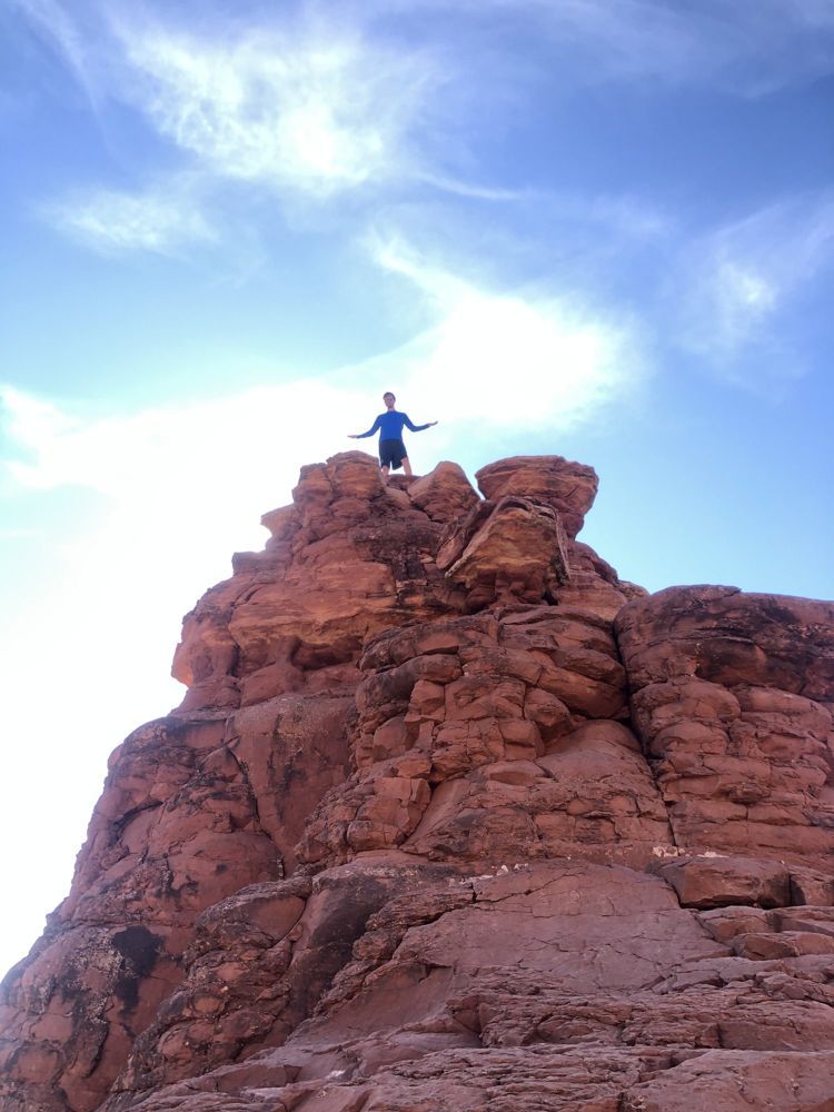 Stephen on top of a red rock formation